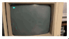 stamp with recording of an old monitor displaying green lines of code